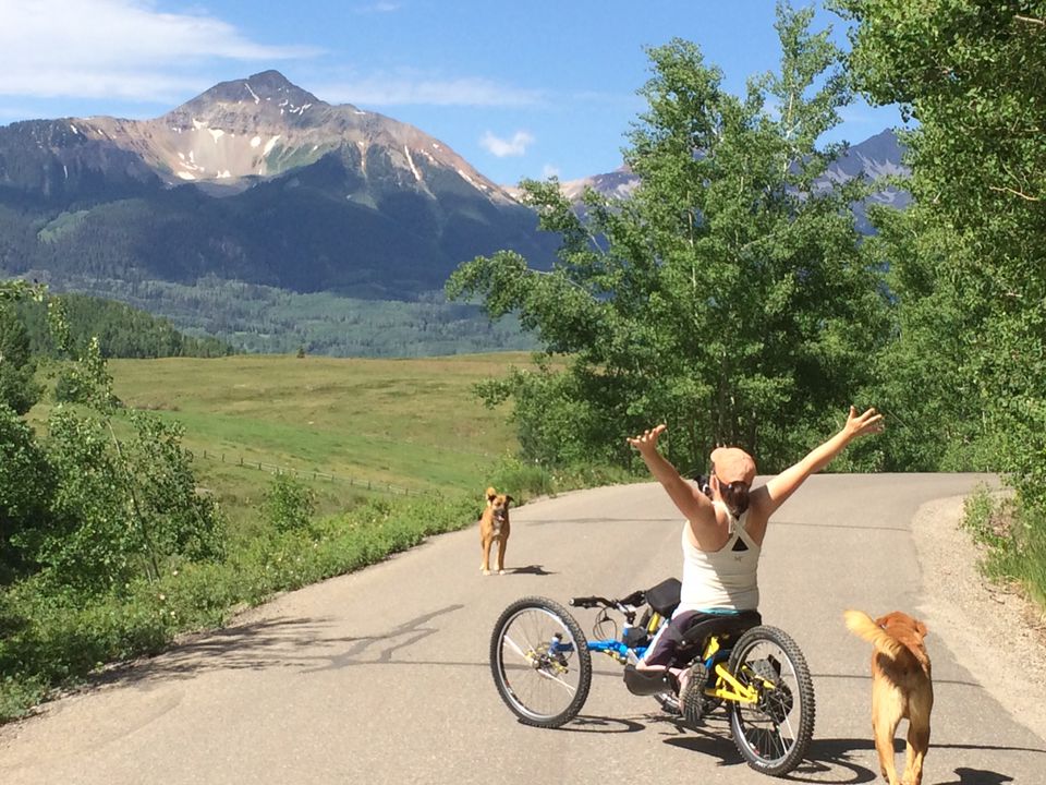 Sylvie biking with her dogs