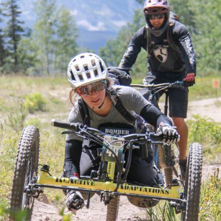Woman riding an offroad hand cycle bicycle.