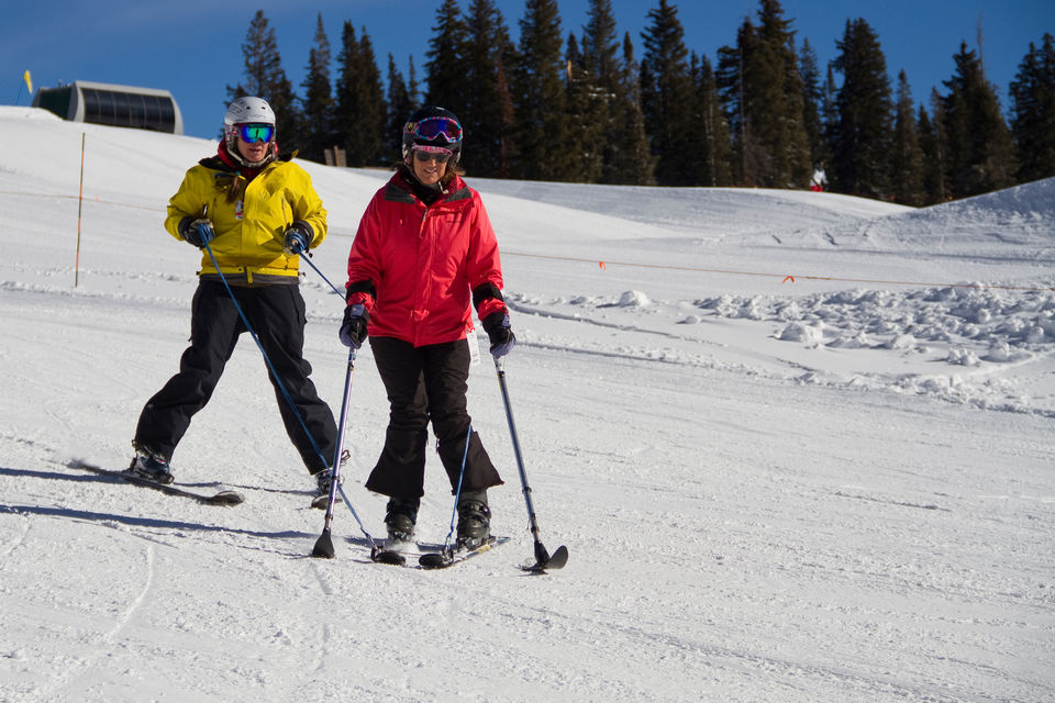 Sara Fischer skiing with instructor Colleen