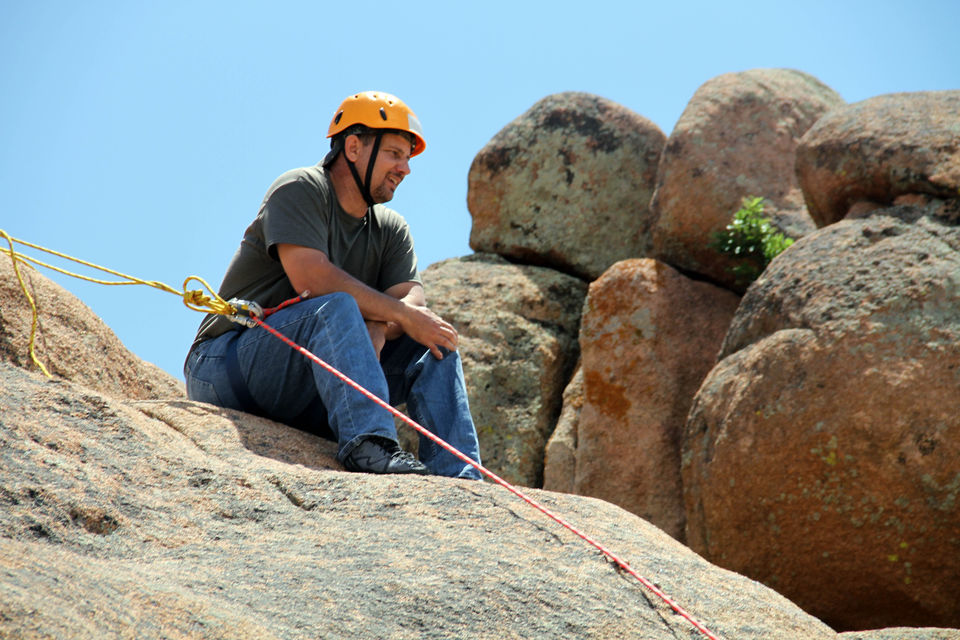 James Tarantella sitting atop the rocks after climbing.